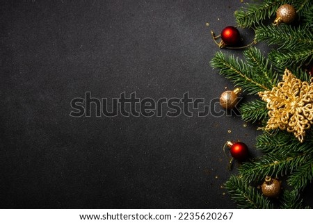 Christmas flat lay background with holiday decorations on black.