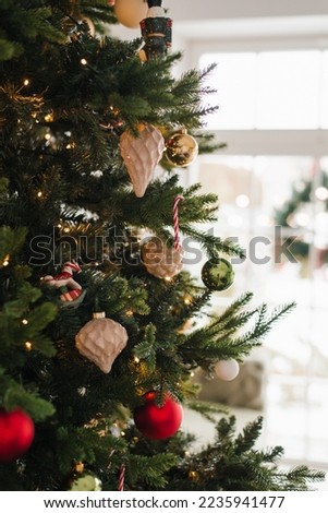Red and gold toys with lights on the Christmas Tree with copy space