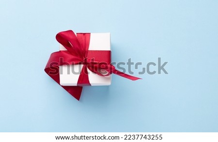 Gift box on blue background. Flat lay with copy space