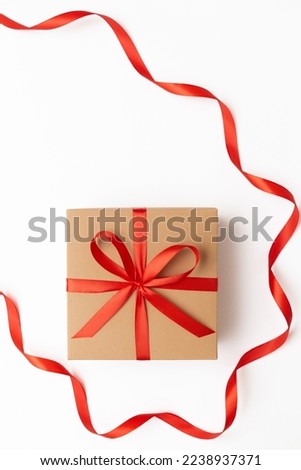 Top view of one craft gift box with red ribbon