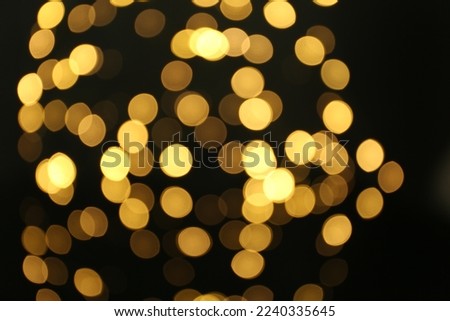 Blurred view of beautiful lights on black background. Bokeh effect