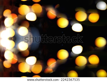 Blurry garland lights on a dark background. Festive Christmas and New Year background. Soft focus.