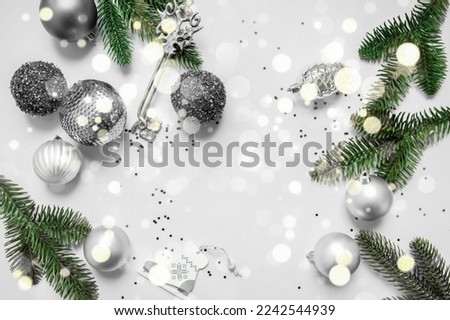 festive New Year's frame layout in black and white tones on a white background. Christmas decorations, fir branches and sparkles. flat lay. top view. copy space