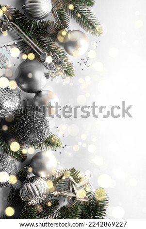 festive New Year's frame layout in black and white tones on a white background. Christmas decorations, fir branches and sparkles. flat lay. top view. copy space