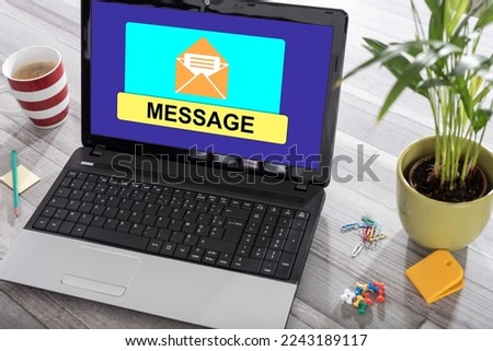 Laptop on a desk with message concept on the screen