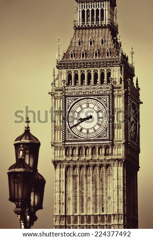 Big Ben closeup in London with vintage lamp post.