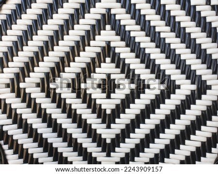A black and white weaving pattern surface of  plastic for background or backdrop