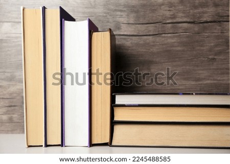 Collection of different books on white shelf