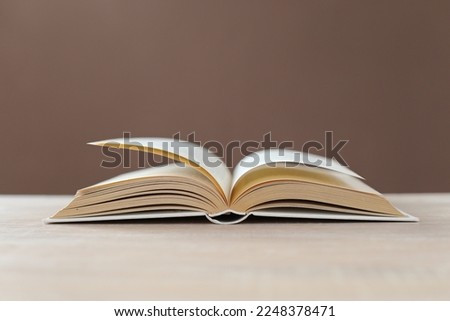 Open book on brown background