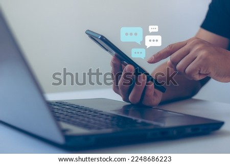 Man hand using smartphone typing, chatting conversation in chat box icons pop up on application in response to communication, Communication Digital Web, social network. Social media marketing concept.