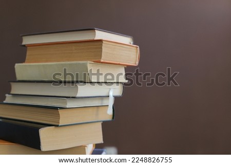 Pile of books on brown background