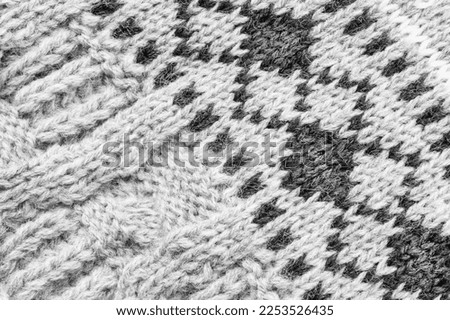 White and black abstract wool knit background closeup