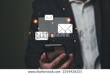 Businessman working in front of laptop computer while check email or online text message from smartphone. Work anywhere concept for new normal, global workplace with wireless internet technology.
