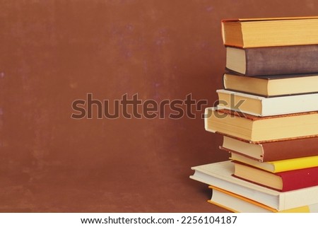 Pile of books on brown background
