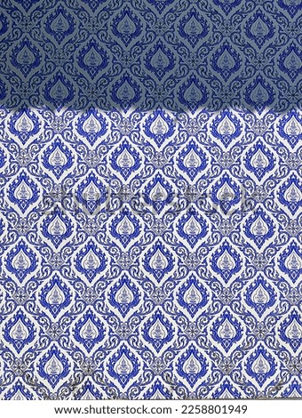 Traditional Thai pattern angle the guardian on blue and white ceramic tile wall