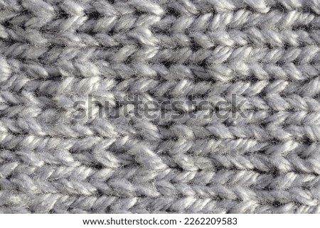 The surface of a soft, fluffy, warm hand-knitted sock.