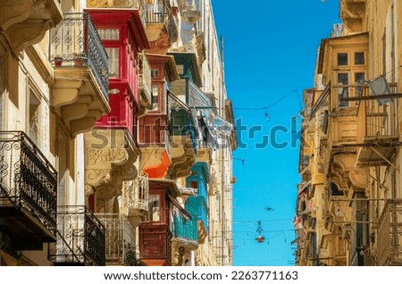 Colorful balconies in a narrow street in Valletta. Traditional Maltese architecture. Old historical part of La Valetta. 