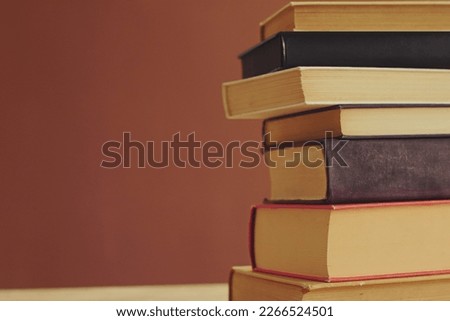 Pile of books on table in school