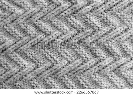 Abstract texture of a knitted bright surface with a pattern.