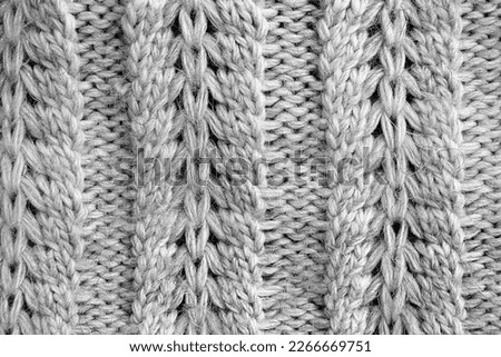 Abstract texture of a knitted bright surface with a pattern.