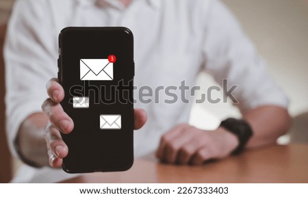 Businessman working in front of laptop computer while check email or online text message from smartphone. Work anywhere concept for new normal, global workplace with wireless internet technology.