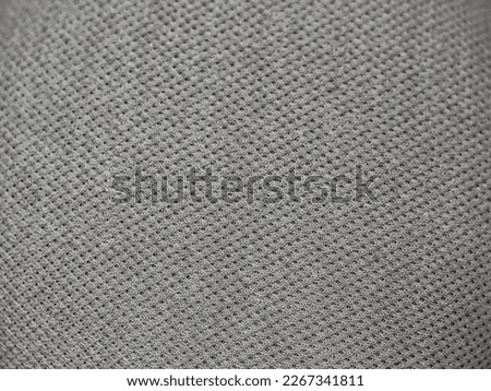 Macro of gray fabric speaker to add subtle texture to your background.