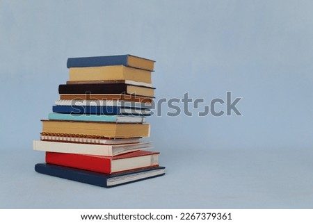 Pile of books on blue background