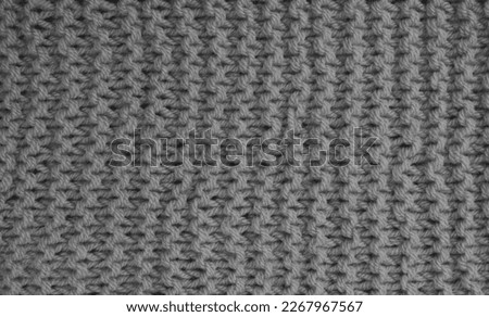 The texture of a knitted wool gray. Background. Abstract background for design with copy space.