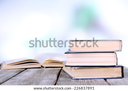 Books on wooden table on natural background