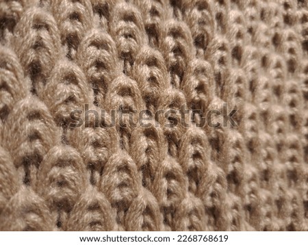 A brown scarf with a coarse fiber texture is perfect for warm clothes in winter