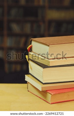 Pile of books on table in library