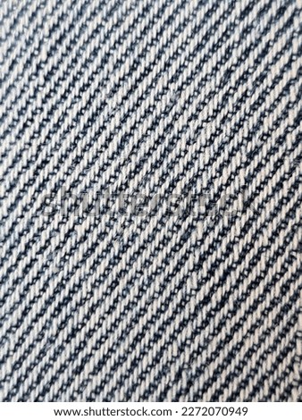 evocative textured image of a blue and white oblique striped patterned fabric
