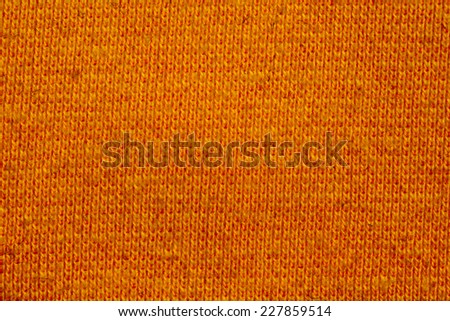 Orange knitting wool texture closeup photo background.