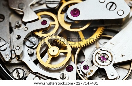 Cogwheels inside old clockwork closeup
