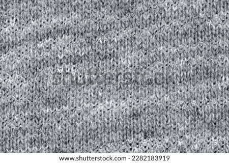 Knitted grey fabric close-up of fleecy threads, uniform texture background 