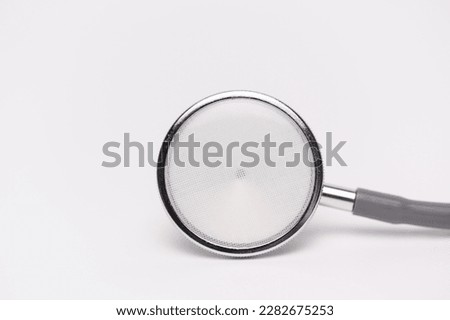 Medical gray stethoscope on white background and copy space for text.Medical or science with soft light background.Health care concept.