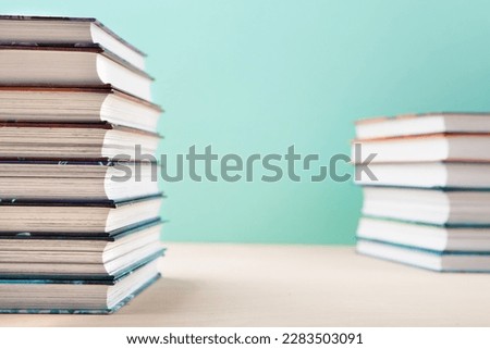 World book and Copyright day, Education concept. Stacks of books on blue mint background. Festive card for books holiday, copy space.