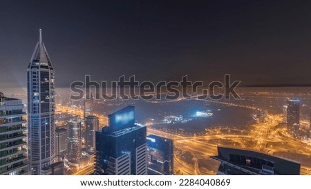 Aerial skyline with Golf Club, hotels and residential areas far away in desert in Dubai during all night  with fog, UAE, top view from Dubai marina skyscrapers. Lights turning off
