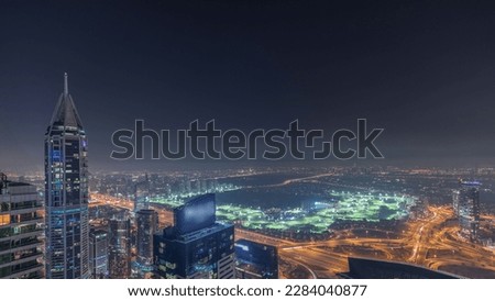 Aerial skyline with Golf Club, hotels and residential areas far away in desert in Dubai night , UAE, top view from Dubai marina skyscrapers