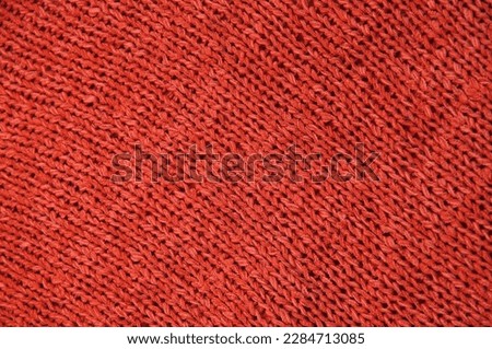 red unusual texture.knitted red sweater close up. handmade concept