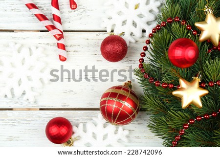 Green Christmas wreath with decorations on wooden background