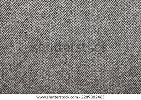 Full frame two tone grey herringbone fabric background with copyspace