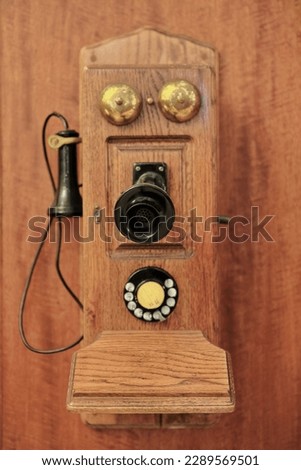Antique wall mounted wood telephone-fiddleback cathedral type with rotary dialer, switch hook, OST pony receiver, transmitter with black metal mouthpiece, two ringers, and crank. Sydney-NSW-Australia.