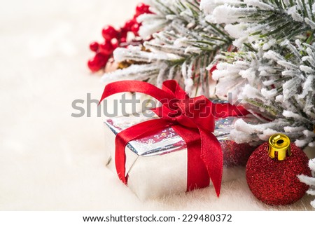 Christmas gifts and decorations on the background of fir branches with space for text