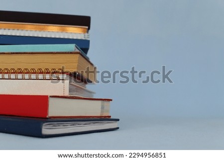 Pile of books on blue background