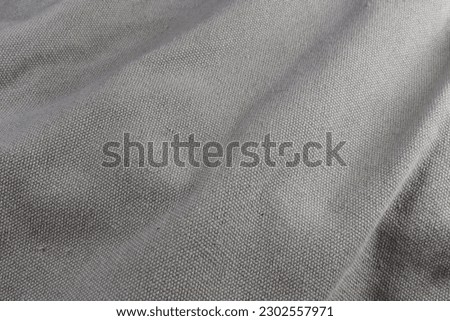 A gray fabric rough background is depicted.