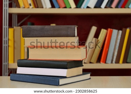 pile of books with stack of book on bookshelf background. education and learning concept