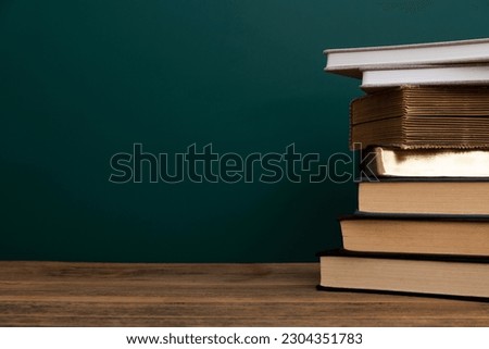 Stack books in front of the blackboard