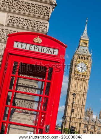 Red call box in London with Big Ben