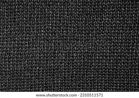 Crochet pattern in black raffia. Wicker texture as a background.